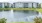 a body of water with buildings in the background
