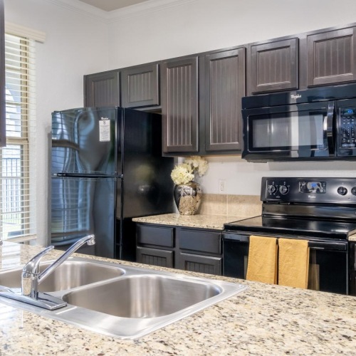 a kitchen with black appliances