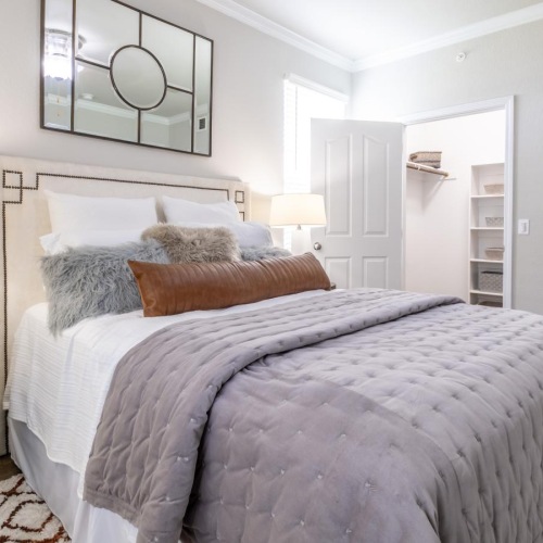 a bedroom with a bed and lamps